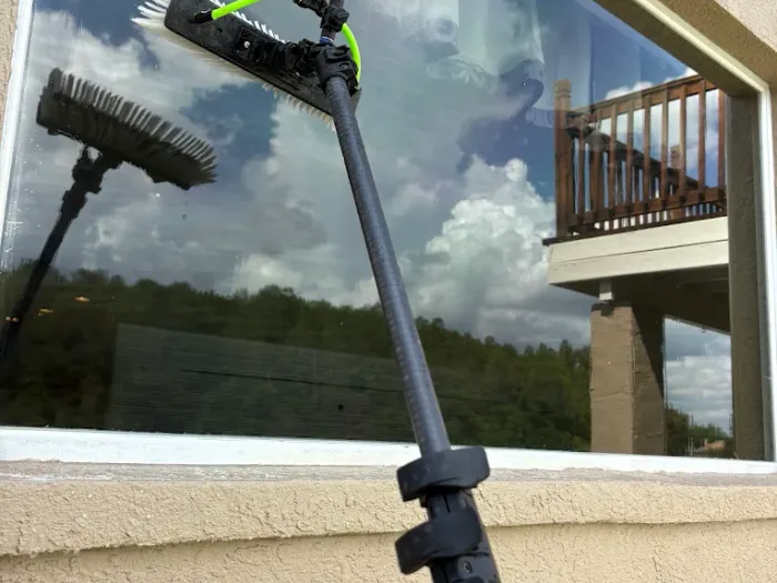 Close-up of the water-fed brush head cleaning a large picture window