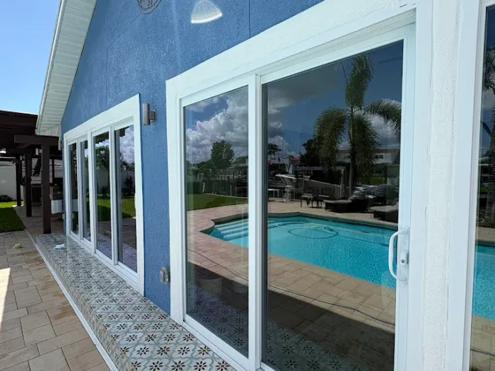 Streak-free sliding glass doors reflecting the pool at a canal-front Tampa home