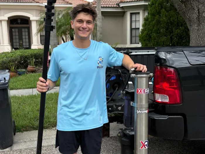 Gavin Meltcher of Pelican Exteriors with the water-fed pole and reverse osmosis tank on a Tampa job