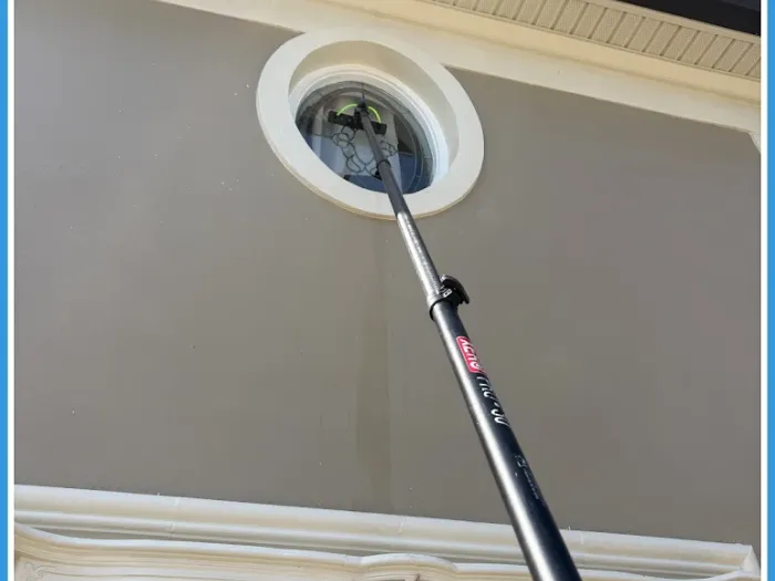 Cleaning an ornate round porthole window on a Tampa luxury home